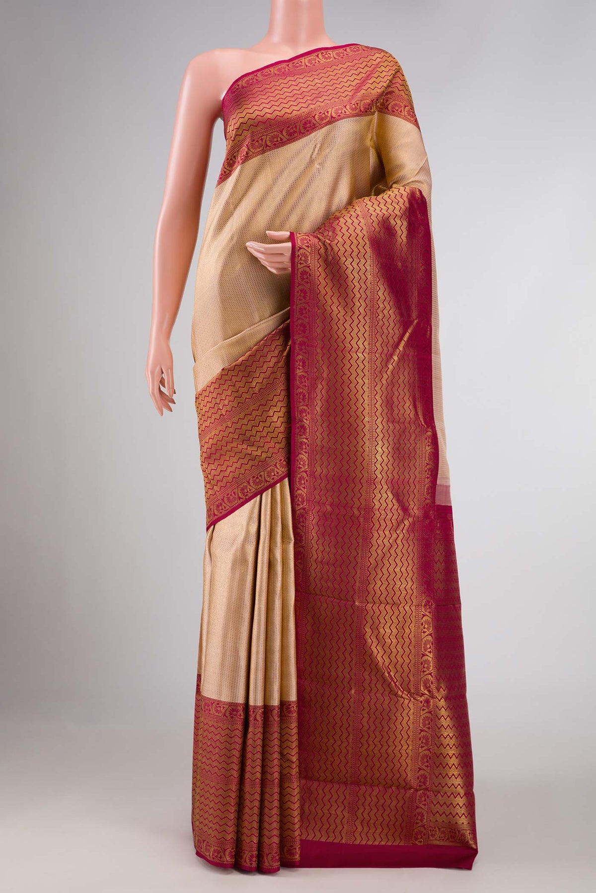 Rose Gold Kanchipuram Silk Saree with Zari Brocade on the body and Zari Border displayed on a mannequin