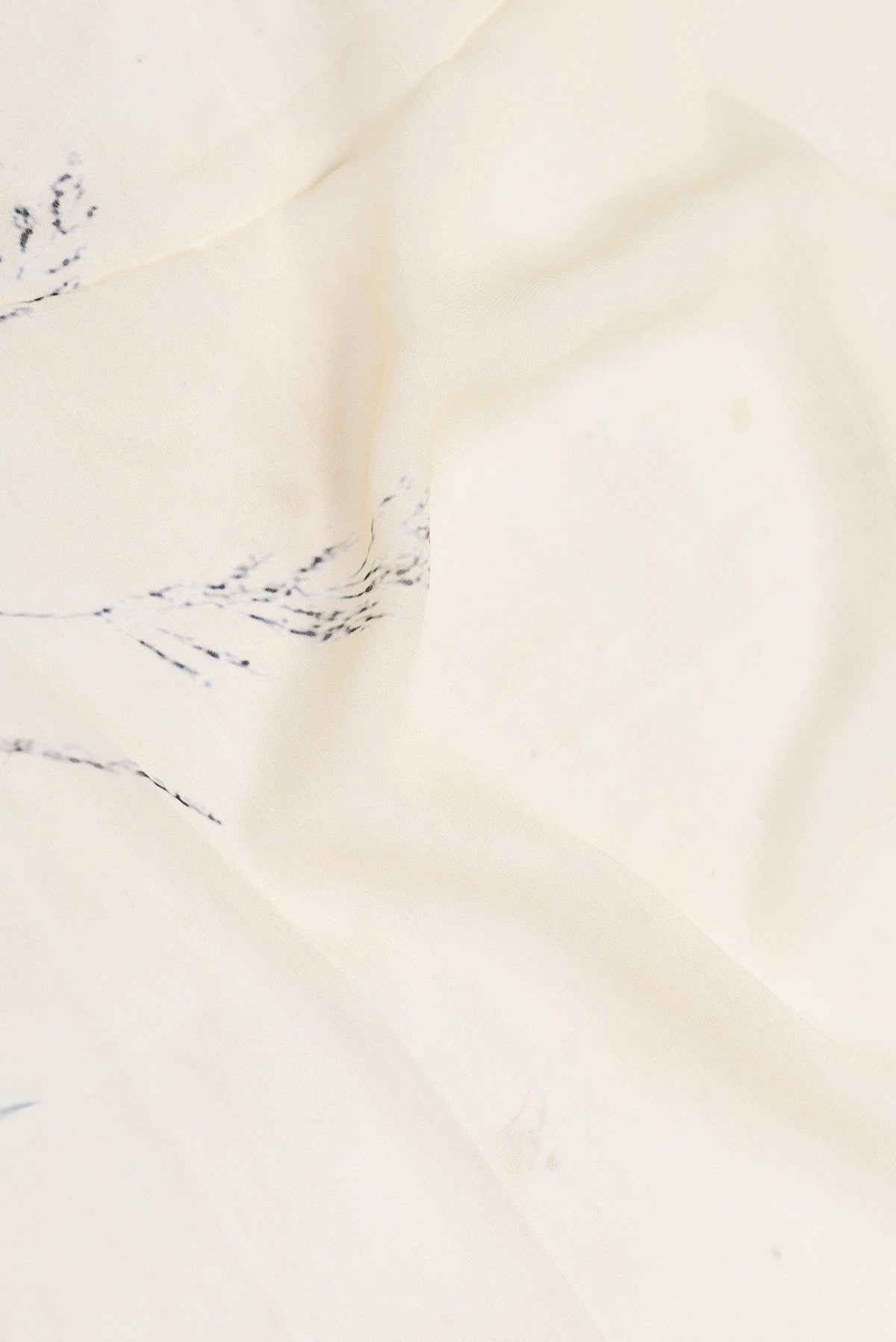 Close up of Sandal Dual Tone Georgette Saree with Printed design on the body and Zari Border displaying folds