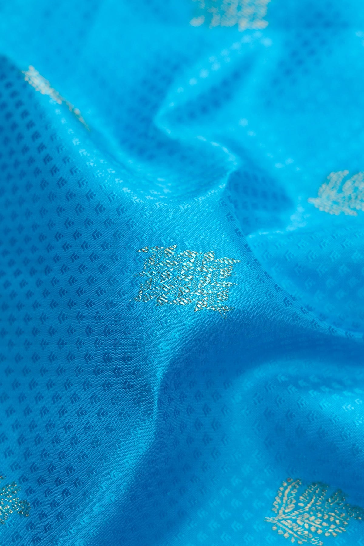 Close up of Pure Silk Pure Zari Sky Blue Dual Tone Kanchipuram Saree with Jacquard With Zari Butta on the body and Zari Border.  displaying folds