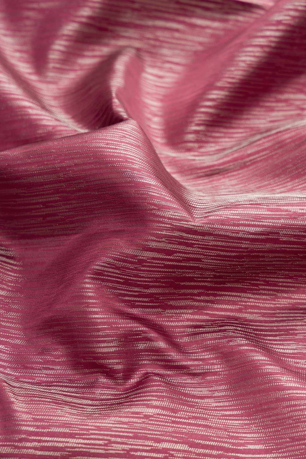 Close up of Dark Mauve Dual Tone Kanchipuram Silk Saree with Zari Brocade on the body and Zari Border displaying folds