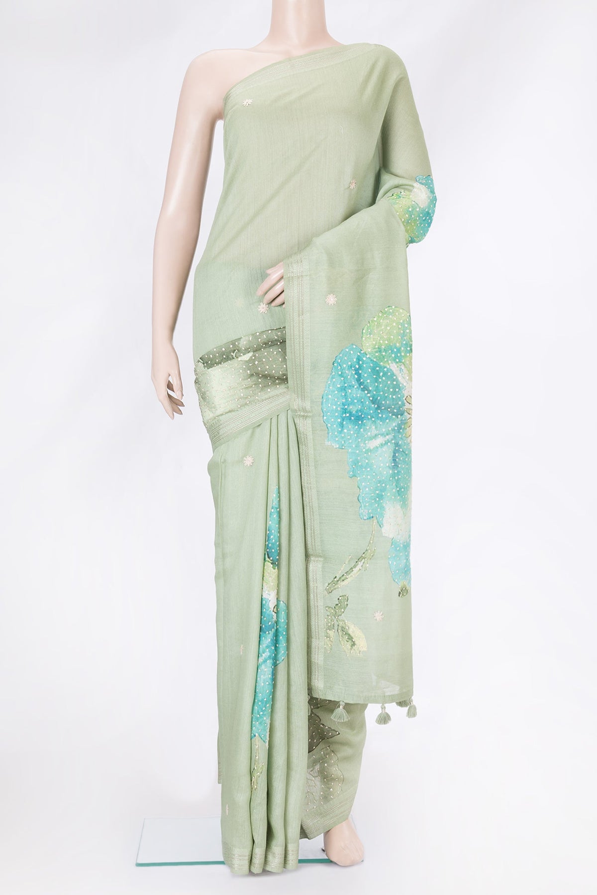 Pista Green Tussar Silk Saree with Embroidery on the body and Zari Border.  displayed on a mannequin