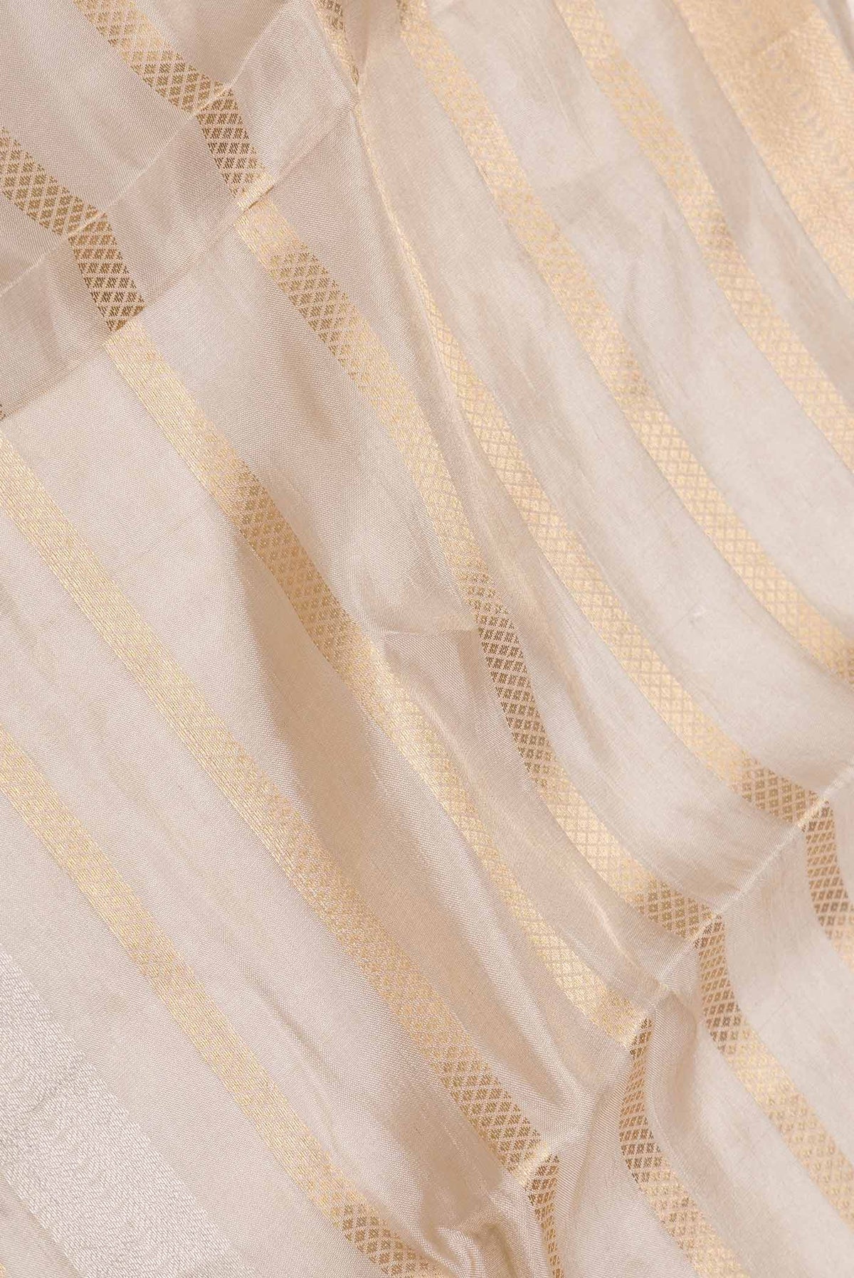 Close up of Gold Dual Tone Organza Silk Saree with Zari Brocade on the body and Zari Border displaying folds