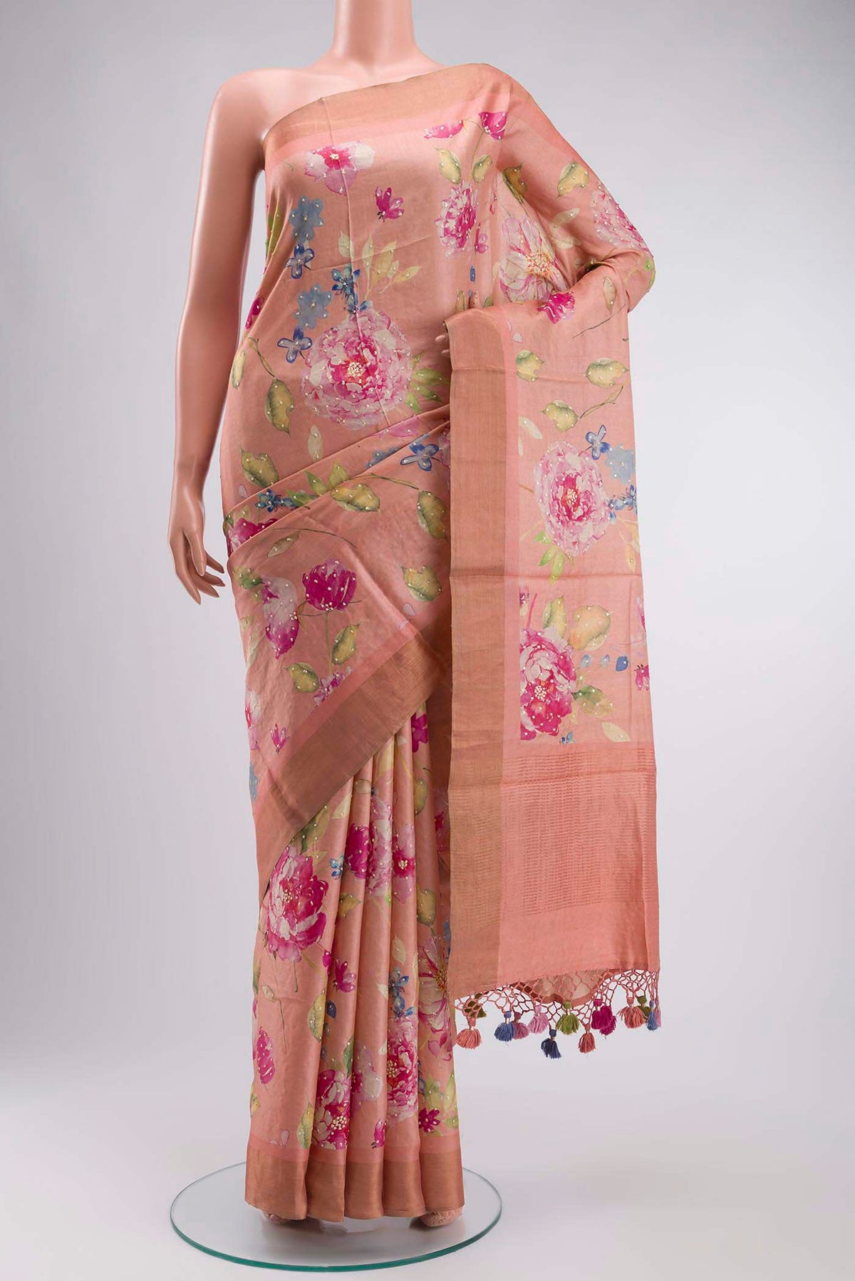 Peach Bhagalpuri Tussar Silk Saree with Printed design on the body and Zari Border displayed on a mannequin