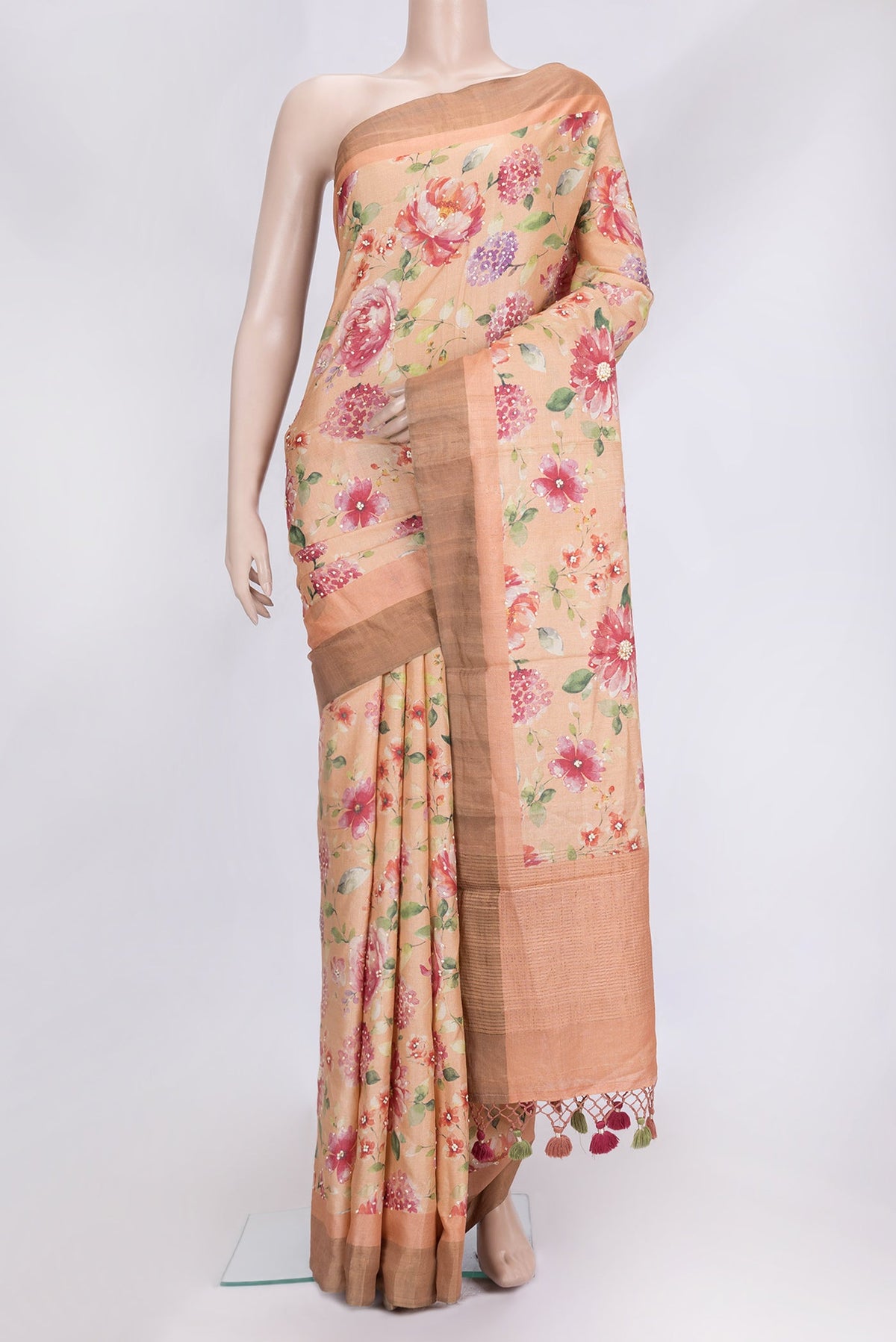Peach Dual Tone Tussar Silk Saree with Embroidery on the body and Zari Border.  displayed on a mannequin