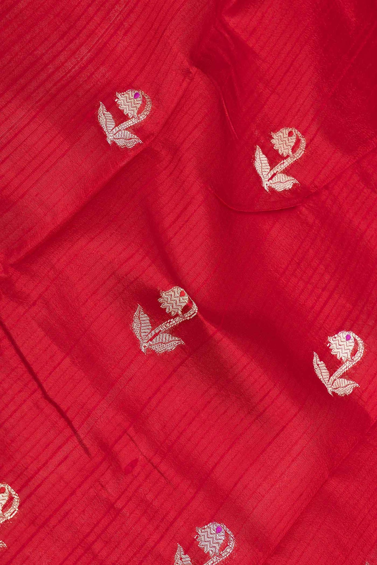 Close up of Red Banarasi Raw Silk Saree with Zari Butta on the body and Zari Border displaying folds