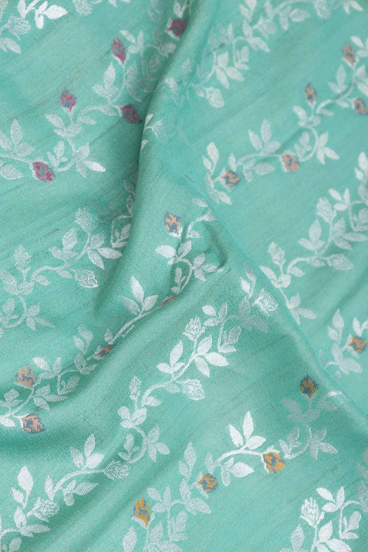Close up of Light Green Dual Tone Banarasi Silk Saree with Zari Brocade on the body and Zari Border displaying folds