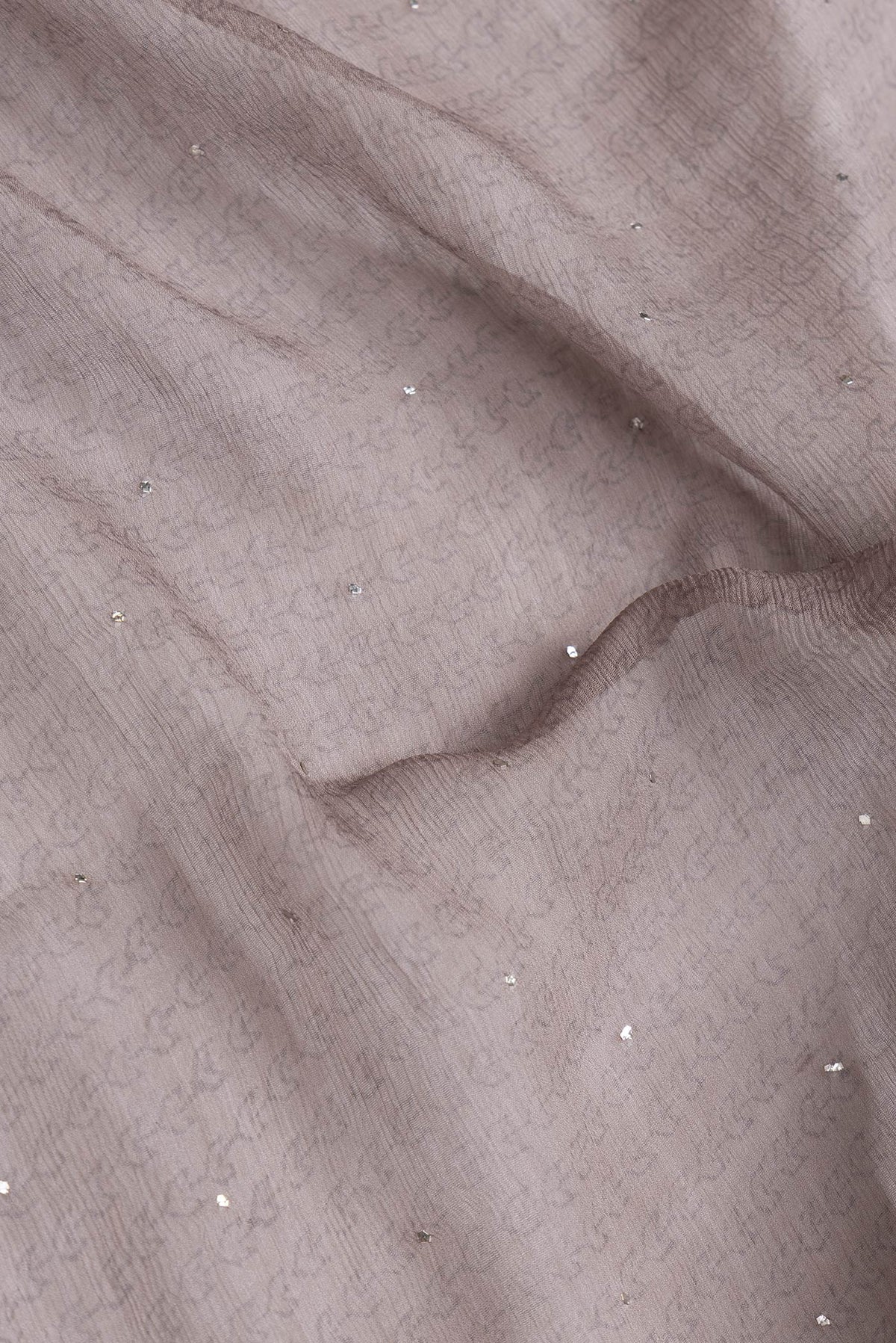 Close up of Grey Dual Tone Mysore Chiffon Saree with Printed design on the body and Embroidery Border.  displaying folds