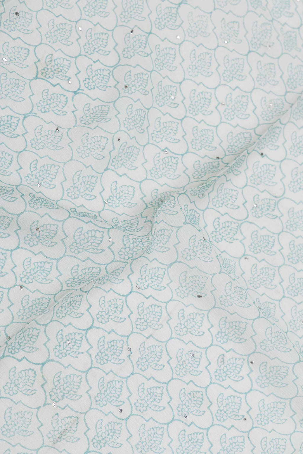 Close up of Grey Dual Tone Mysore Crepe Saree with Printed design on the body and Zari Border displaying folds