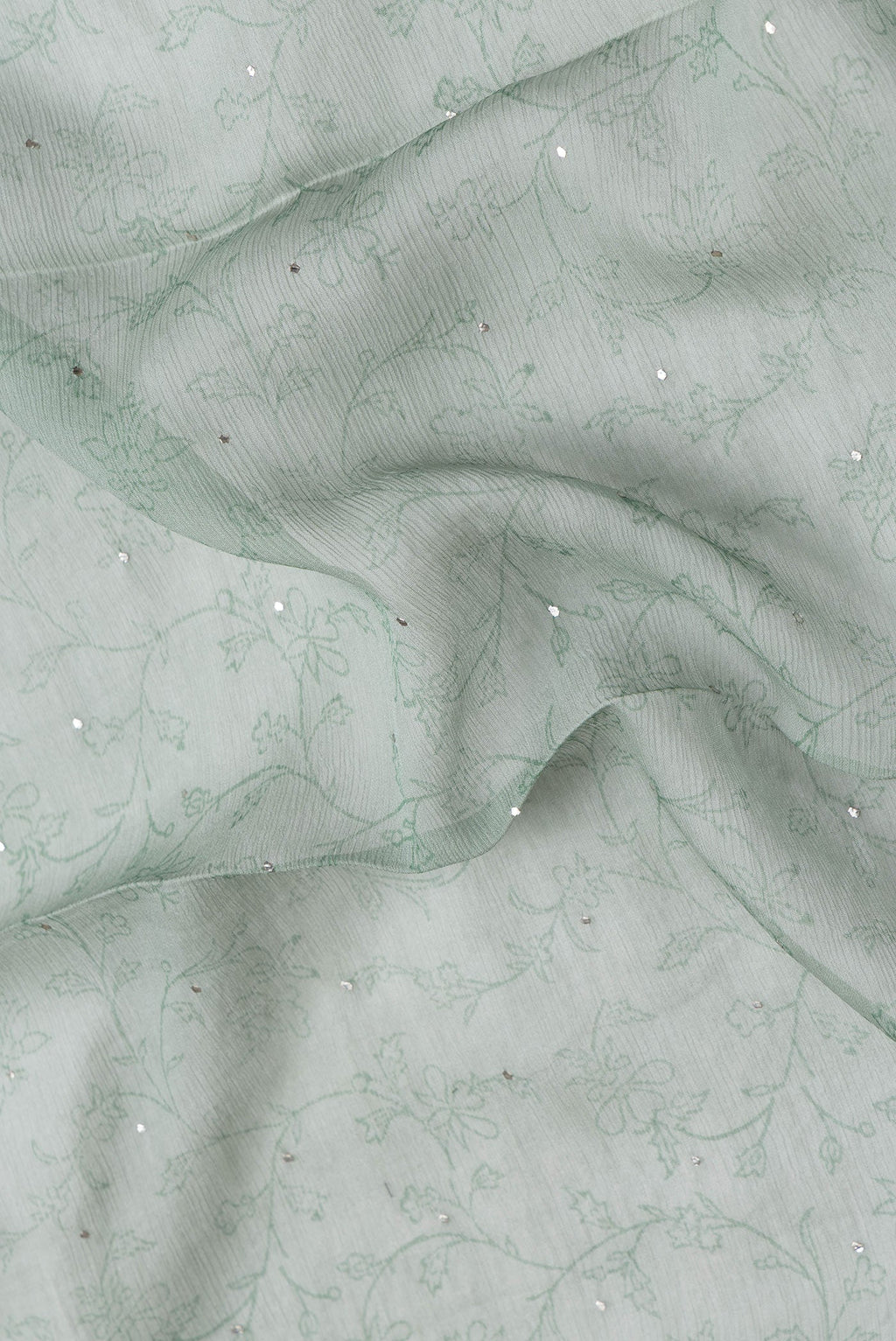 Close up of Light Green Dual Tone Mysore Chiffon Saree with Embroidery on the body and Embroidery Border.  displaying folds