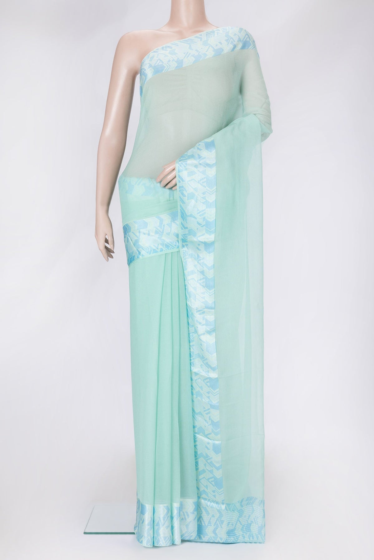 Sea Green Dual Tone Mysore Chiffon Saree with Plain Body and Thread Border.  displayed on a mannequin