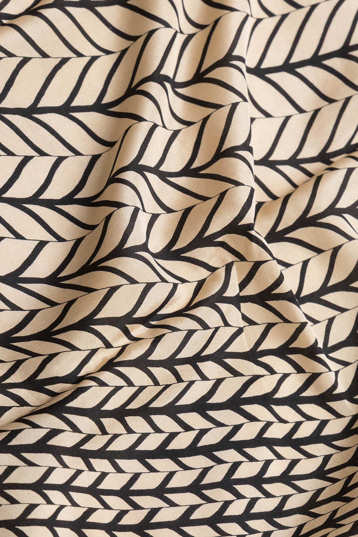 Close up of Beige Dual Tone Mysore Crepe Saree with Printed design on the body and Plain Border.  displaying folds