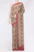 Beige Crepe Saree with Printed design on the body and Printed Border.  displayed on a mannequin