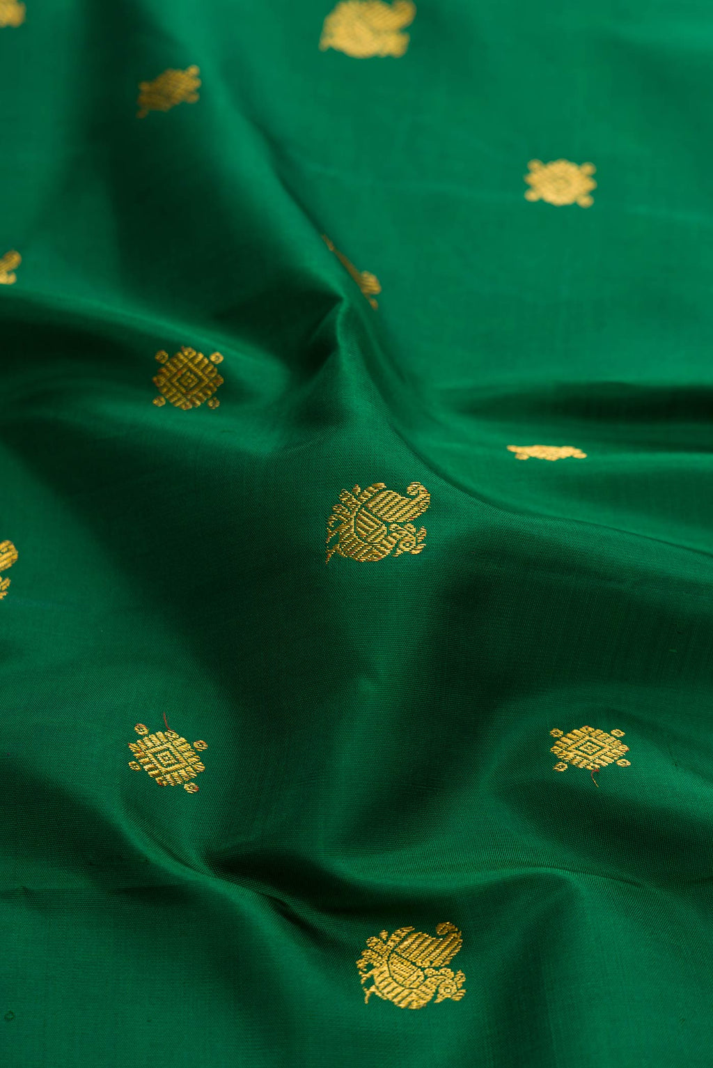 Close up of Bottle Green Dual Tone Kanchipuram Silk Saree with Zari Butta on the body and Zari Border displaying folds