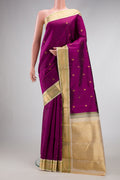 Pure Silk Pure Zari Magenta Dual Tone Kanjivaram Saree with Zari Butta on the body and Zari Border.  displayed on a mannequin