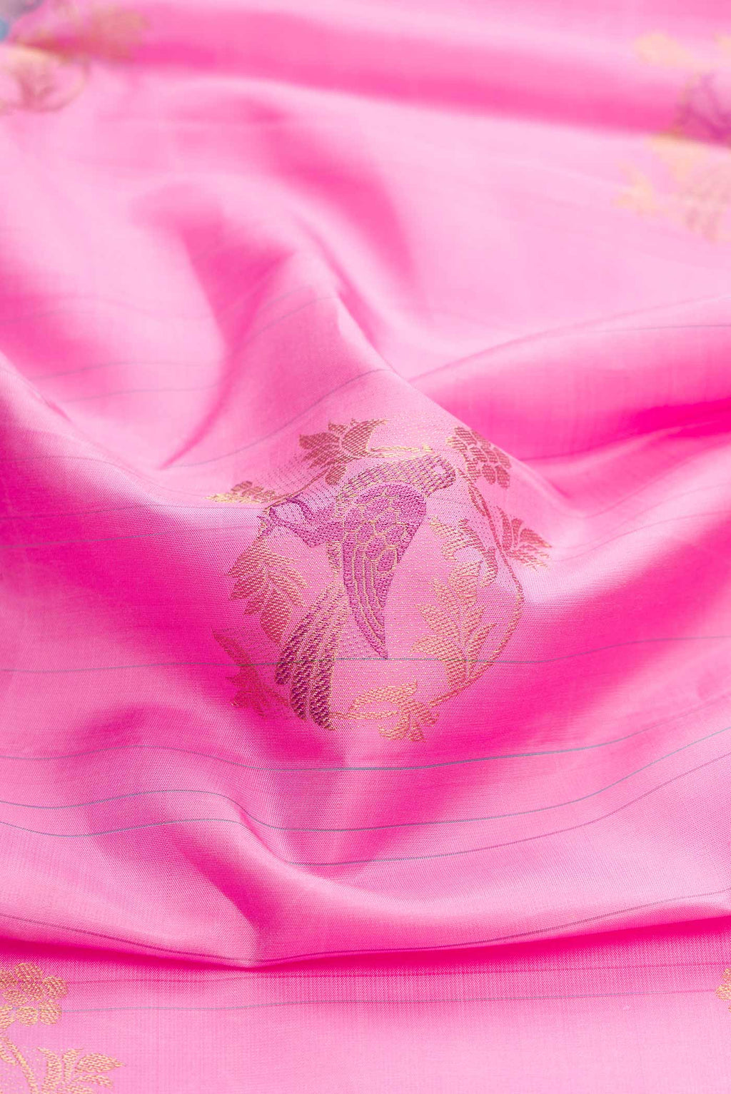 Close up of Pure Silk Pure Zari Pink Dual Tone Kanchipuram Saree with Zari And Thread Butta on the body and Without Border displaying folds