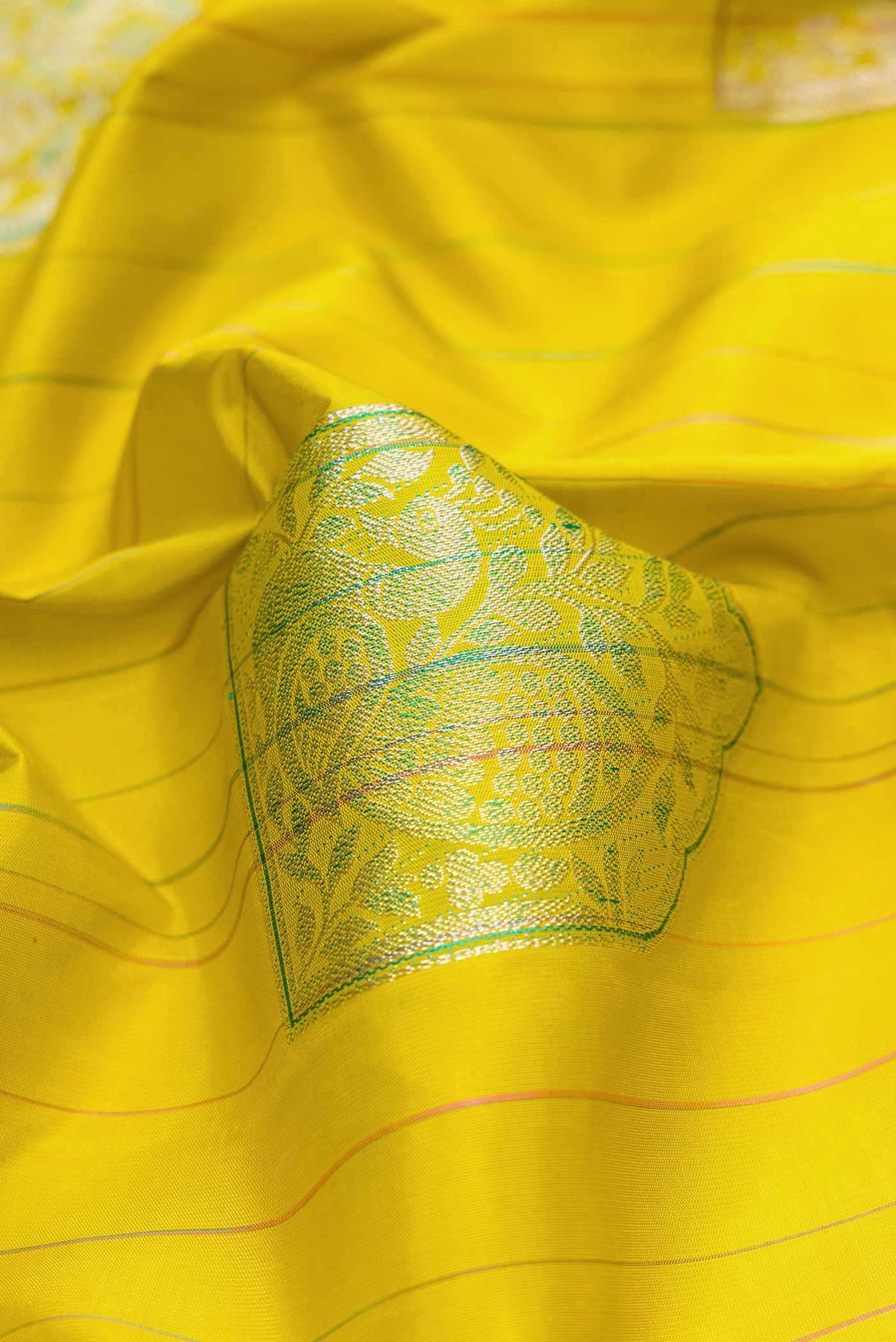 Close up of Pure Silk Pure Zari Mehandi Green Dual Tone Kanchipuram Saree with Stripes on the body and Without Border displaying folds