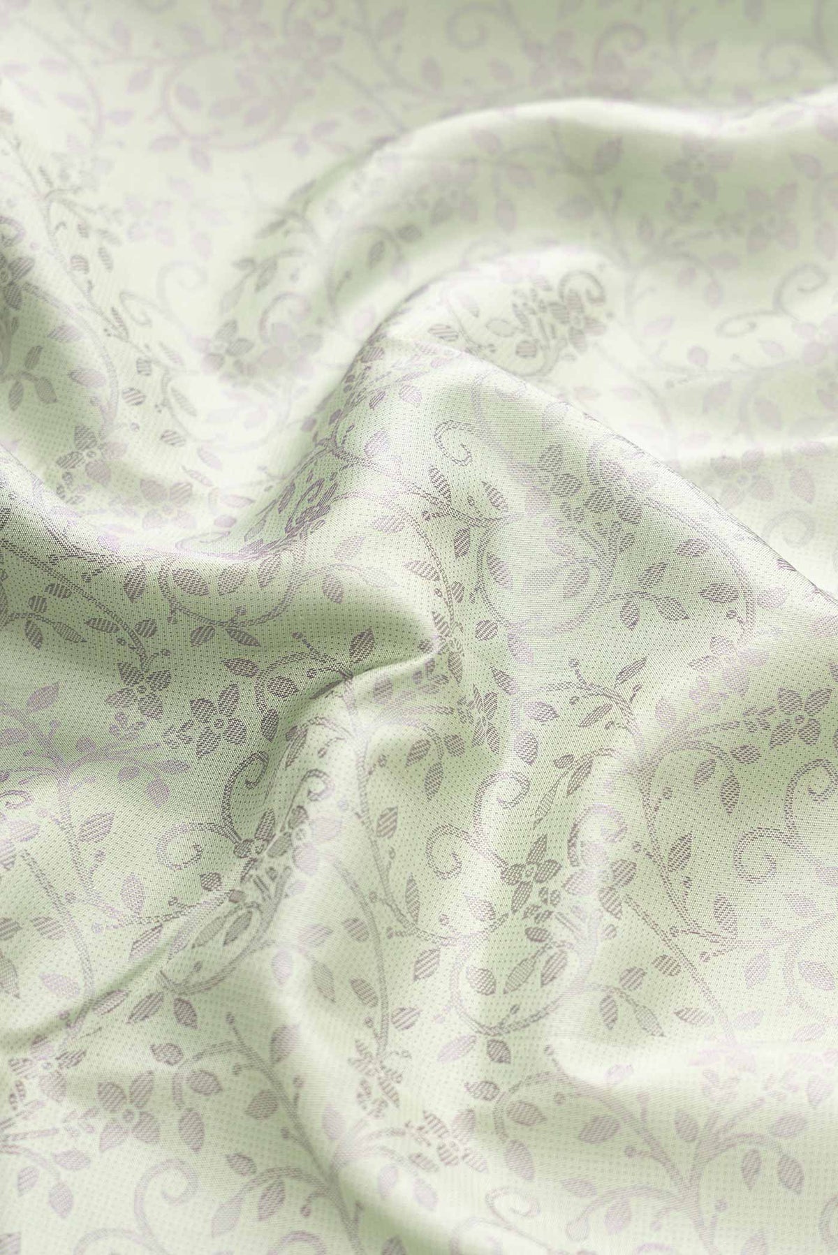 Close up of Pista Green Dual Tone Kanchipuram Silk Saree with Jacquard design on the body and Fancy Border displaying folds