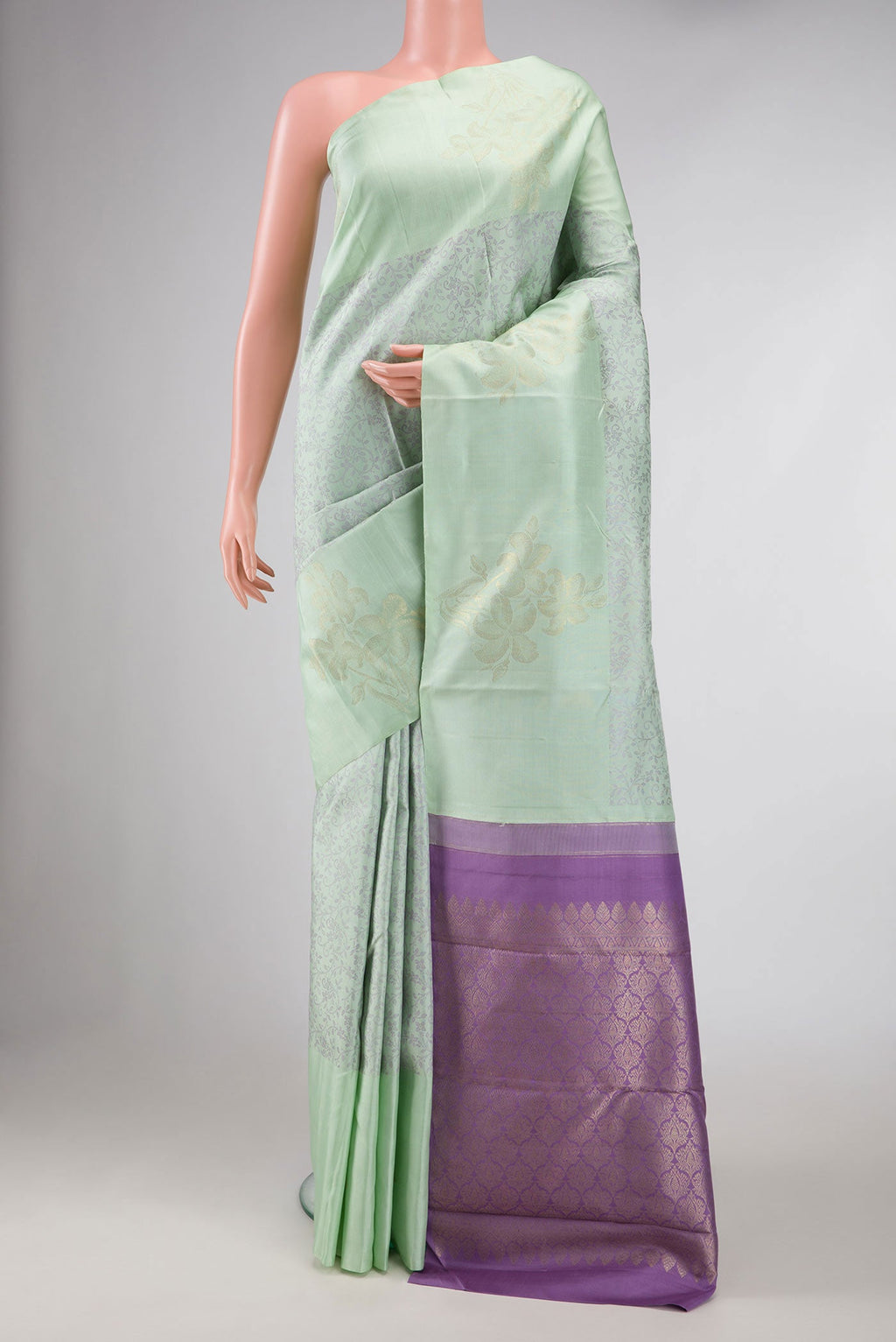 Pista Green Dual Tone Kanchipuram Silk Saree with Jacquard design on the body and Fancy Border displayed on a mannequin