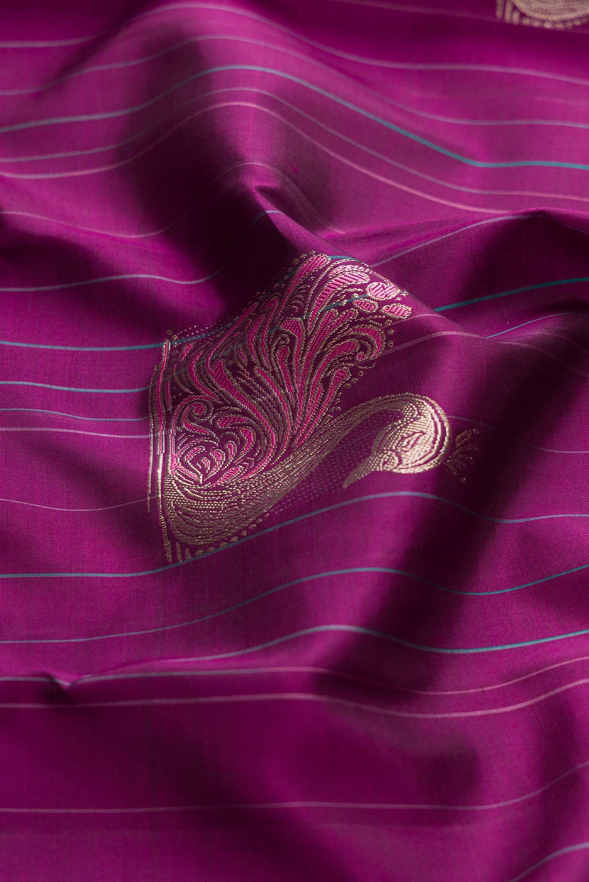 Close up of Purple Dual Tone Kanchipuram Silk Saree with Zari And Thread Butta on the body and Without Border displaying folds