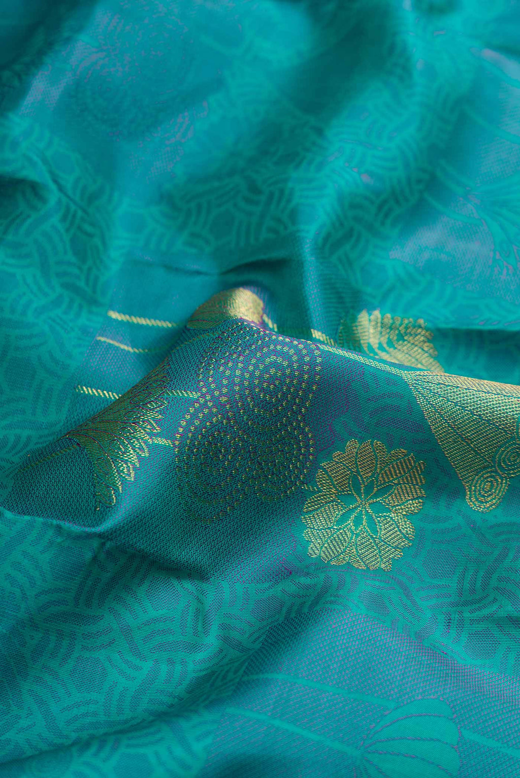 Close up of Sea Green Dual Tone Kanchipuram Silk Saree with Jacquard With Zari Butta on the body and Without Border displaying folds
