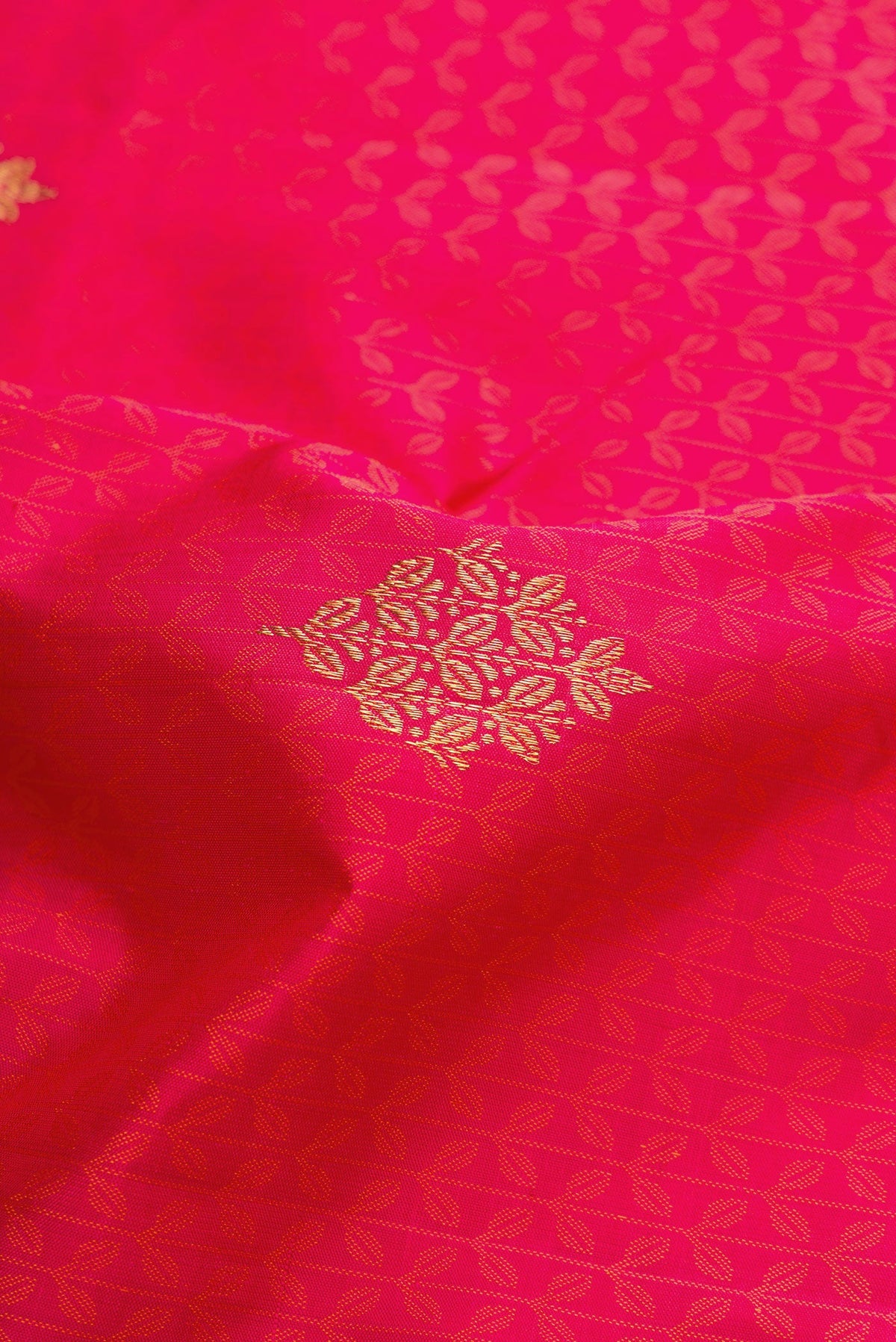 Close up of Pure Silk Pure Zari Pink Dual Tone Kanchipuram Saree with Jacquard With Zari Butta on the body and Zari Border.  displaying folds