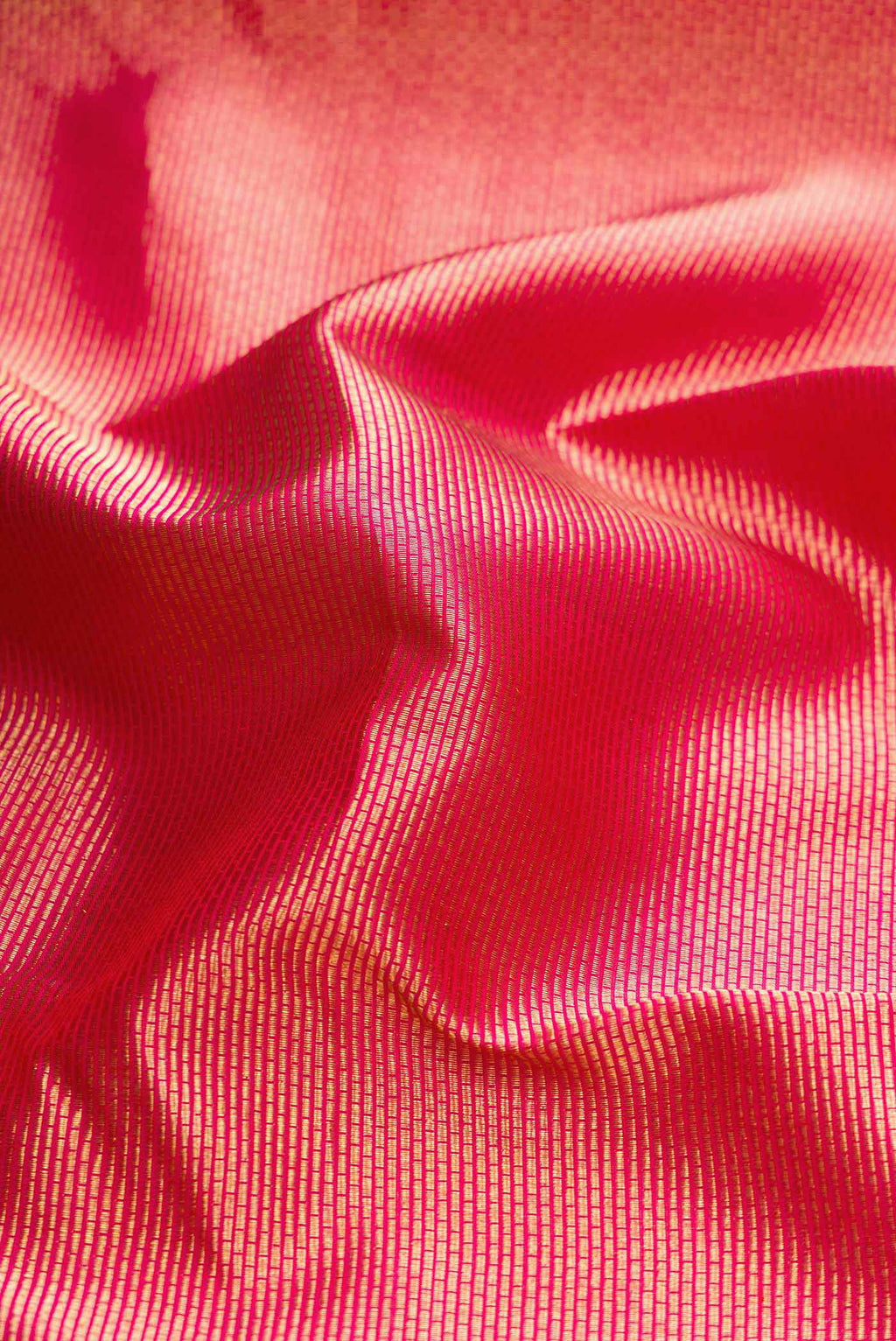Close up of Dark Pink Dual Tone Kanchipuram Silk Saree with Zari Brocade on the body and Zari Border displaying folds