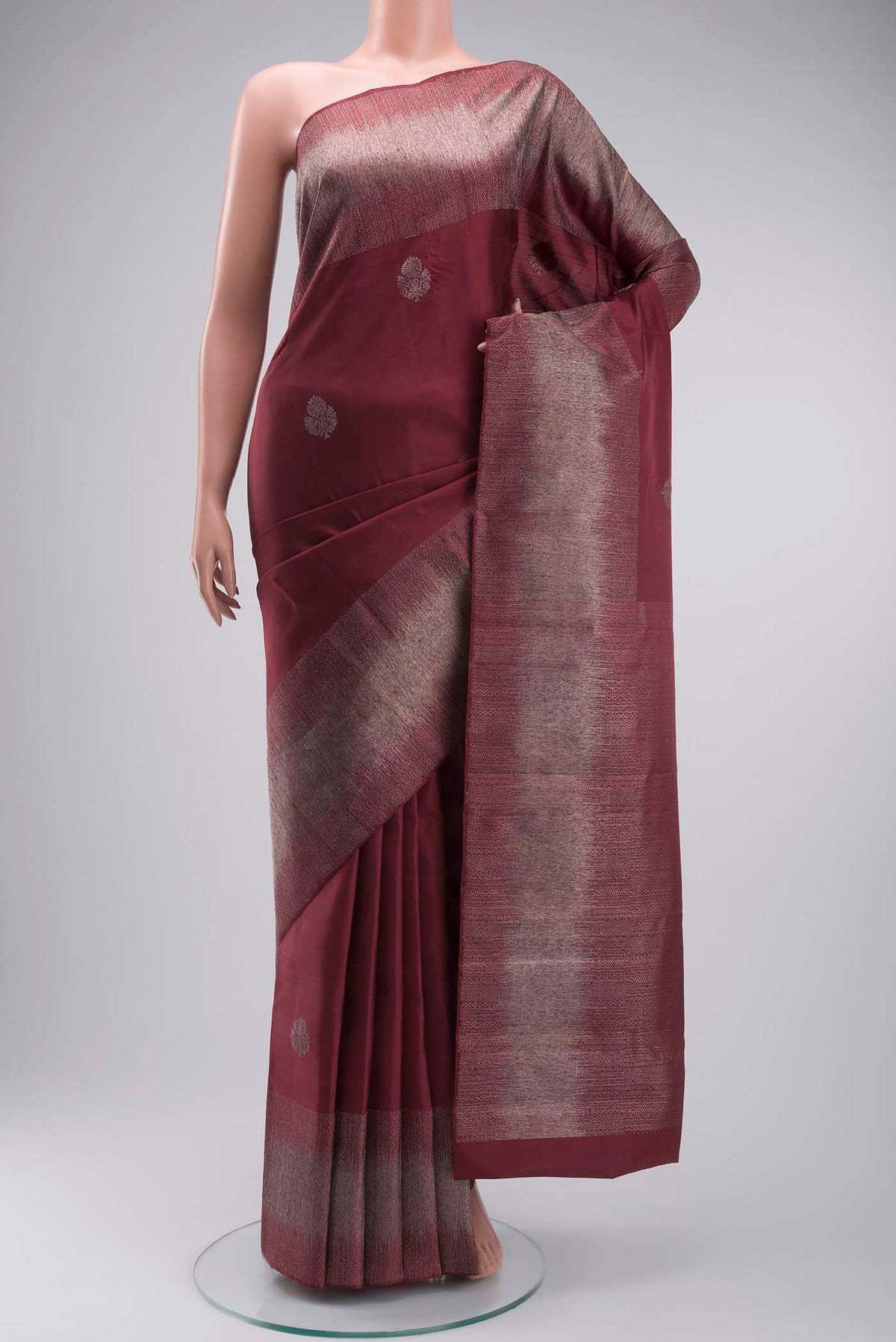 Maroon Kanchipuram Silk Saree with Zari Butta on the body and Zari Border displayed on a mannequin