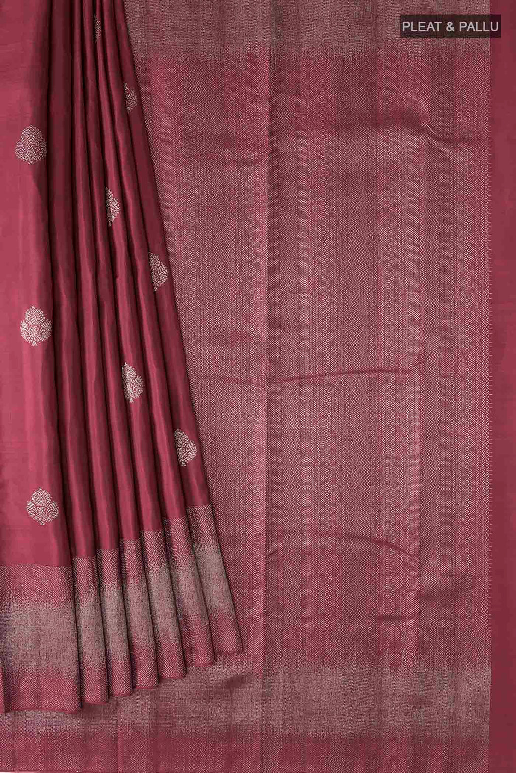 Pleats and pallu of Maroon Kanchipuram Silk Saree with Zari Butta on the body and Zari Border