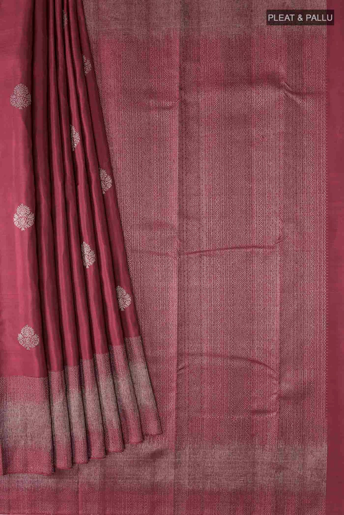 Pleats and pallu of Maroon Kanchipuram Silk Saree with Zari Butta on the body and Zari Border