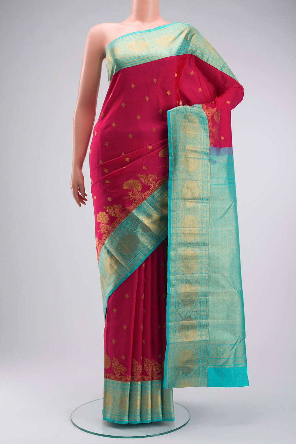 Pink Kanchipuram Silk Saree with Zari Butta on the body and Zari Border displayed on a mannequin
