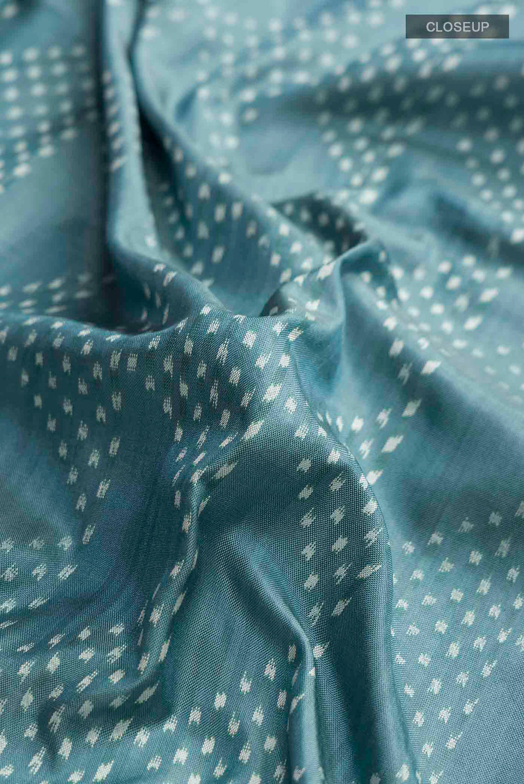 Close up of Grey Pochampally Silk Saree with Pure Ikat on the body and Plain Border displaying folds