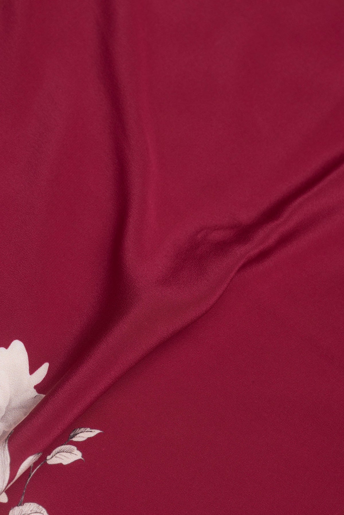 Close up of Dark Pink Dual Tone Crepe Saree with Printed design on the body and Without Border.  displaying folds