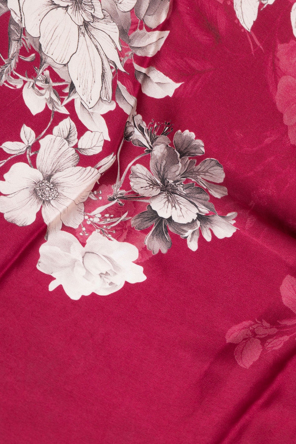 Close up of Dark Pink Dual Tone Mysore Crepe Saree with Printed design on the body and Zari Border.  displaying folds