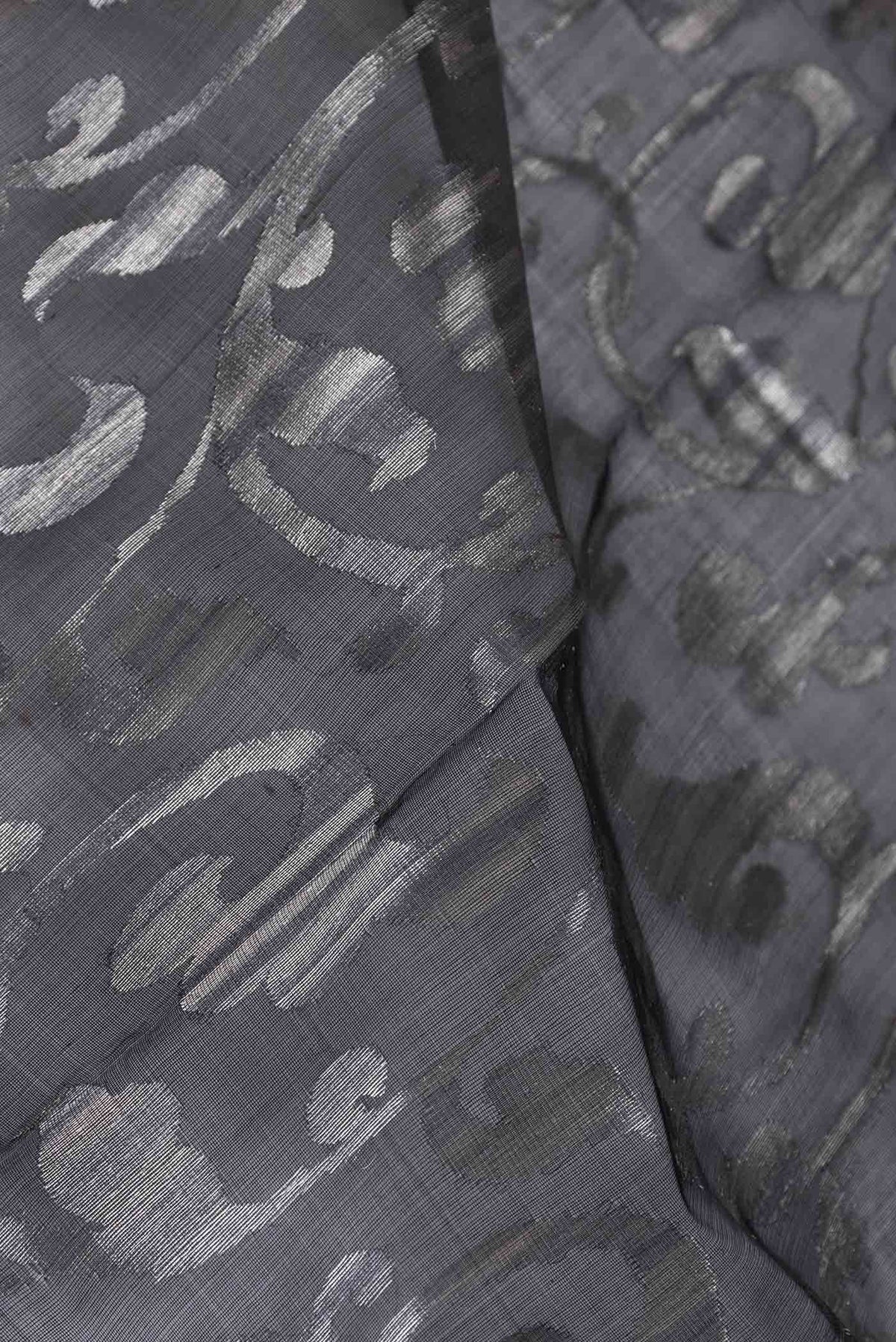 Close up of Black Dual Tone Organza Silk Saree with Zari Brocade on the body and Zari Border displaying folds