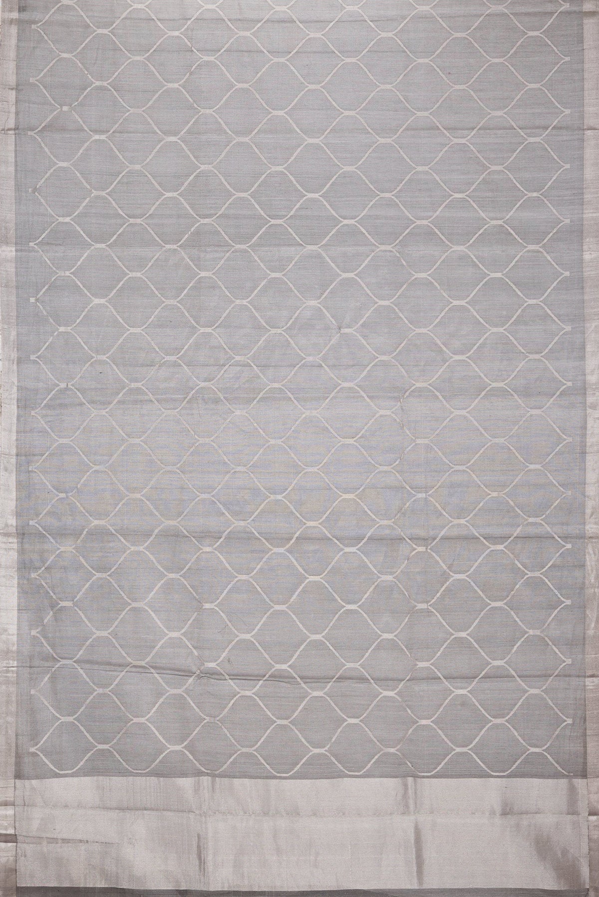 Flat view of Grey Dual Tone Organza Silk Saree with Zari Brocade on the body and Zari Border. 
