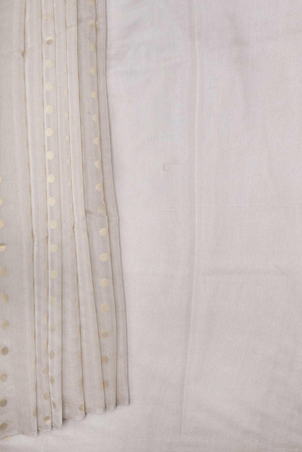 Pleats and pallu of Beige Dual Tone Chanderi Silk Saree with Zari Butta on the body and Thin Zari Line. 