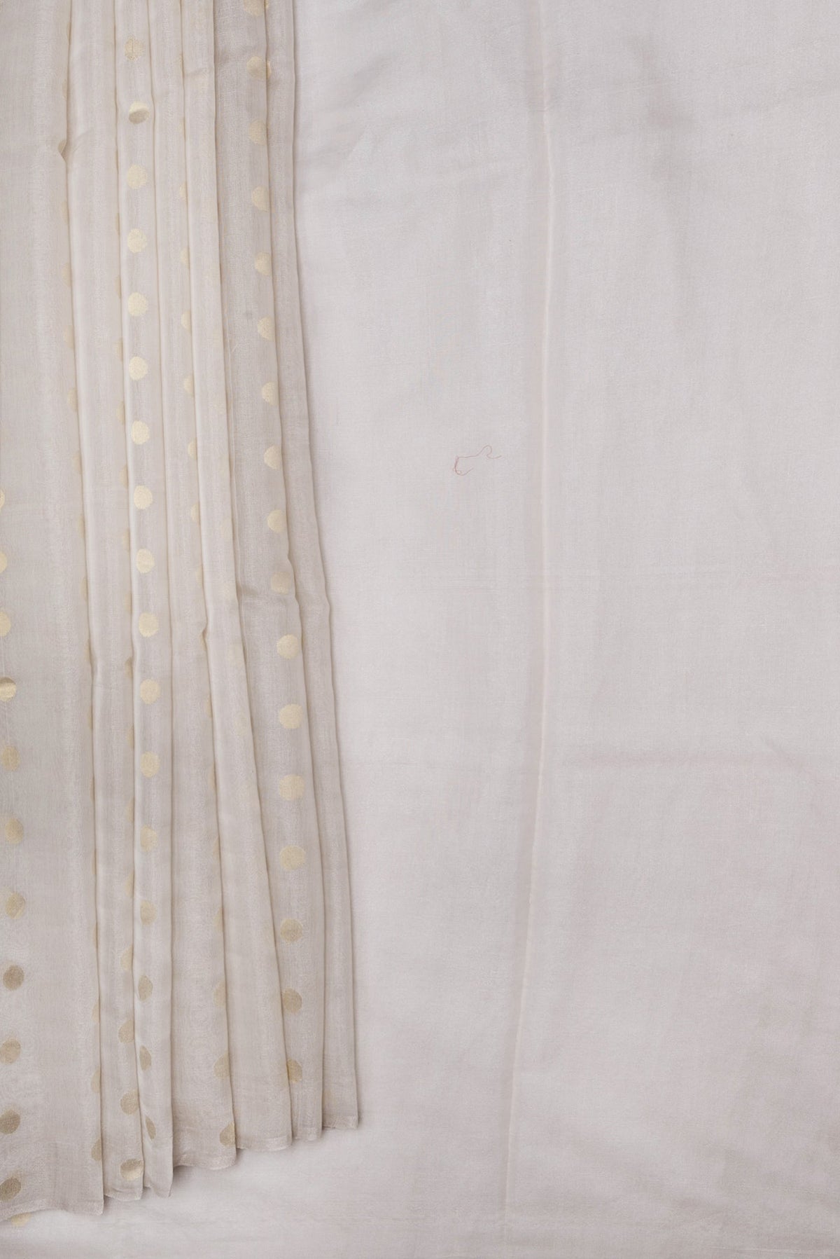 Pleats and pallu of Beige Dual Tone Chanderi Silk Saree with Zari Butta on the body and Thin Zari Line. 