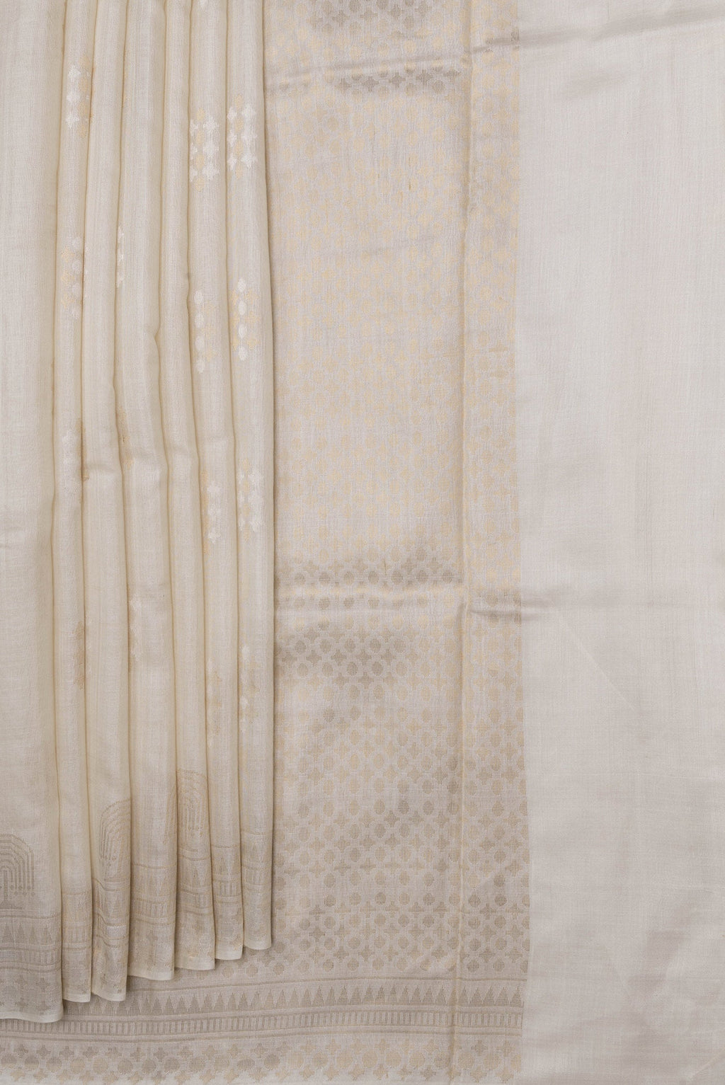Pleats and pallu of Beige Dual Tone Tussar Silk Saree with Zari Butta on the body and Fancy Border. 