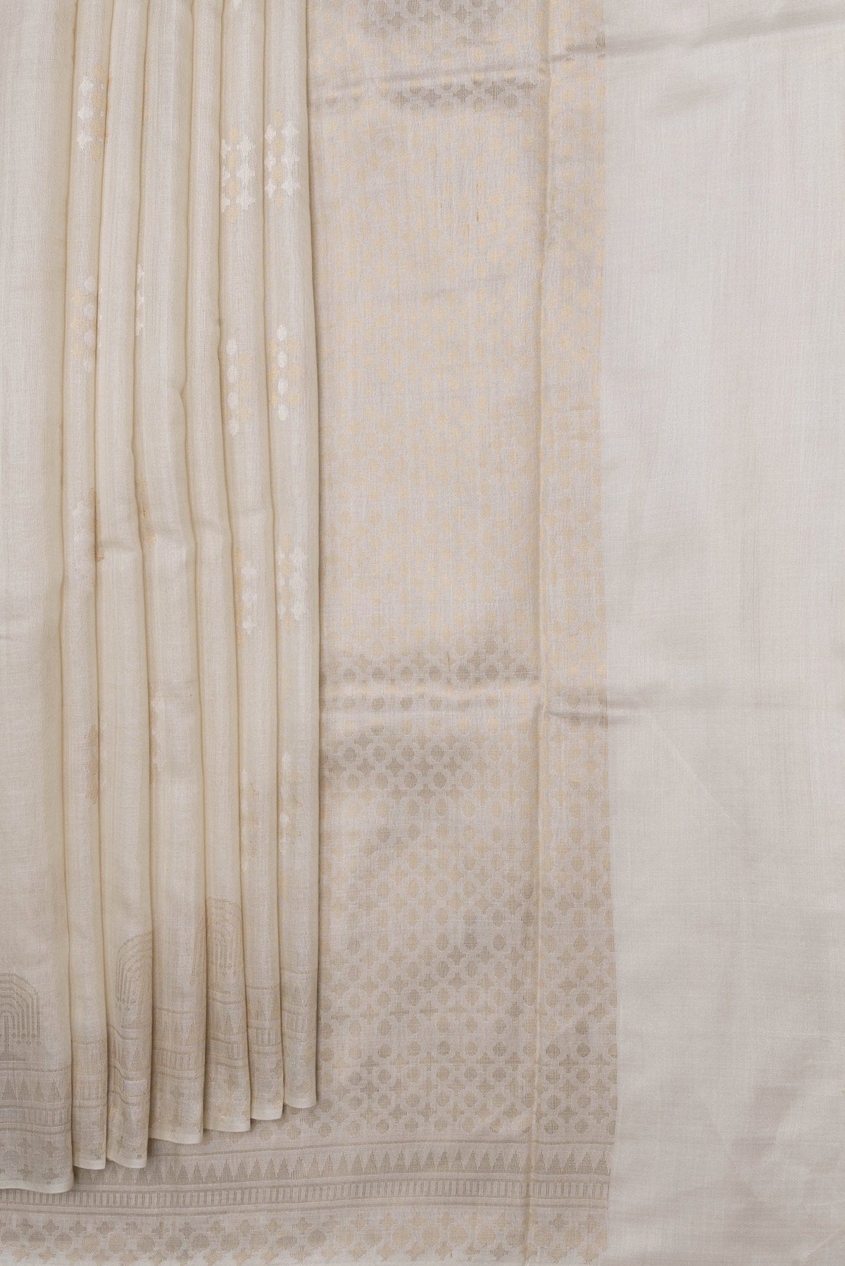 Pleats and pallu of Beige Dual Tone Tussar Silk Saree with Zari Butta on the body and Fancy Border. 