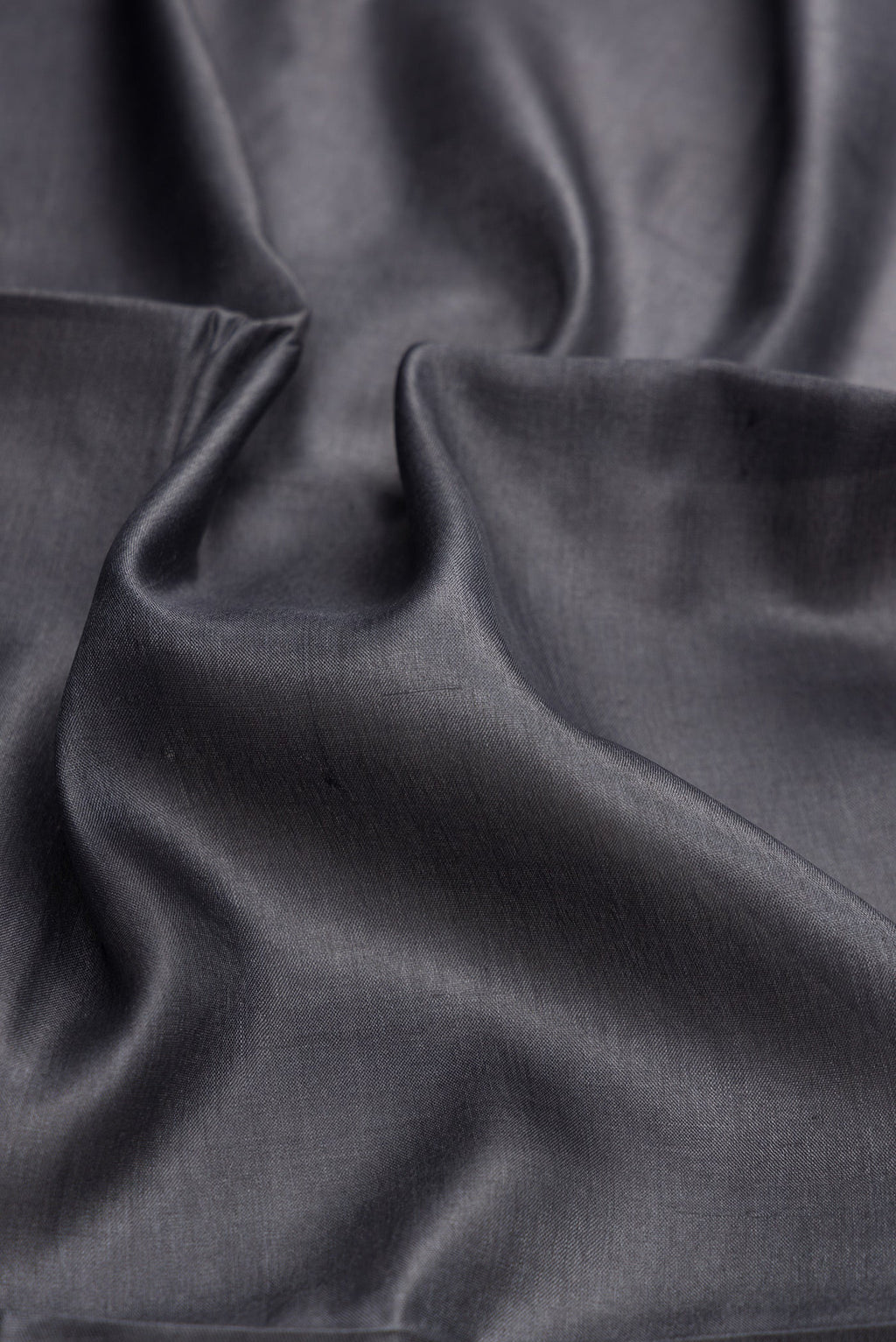 Close up of Grey Dual Tone Tussar Silk Saree with Plain Body and Fancy Border.  displaying folds