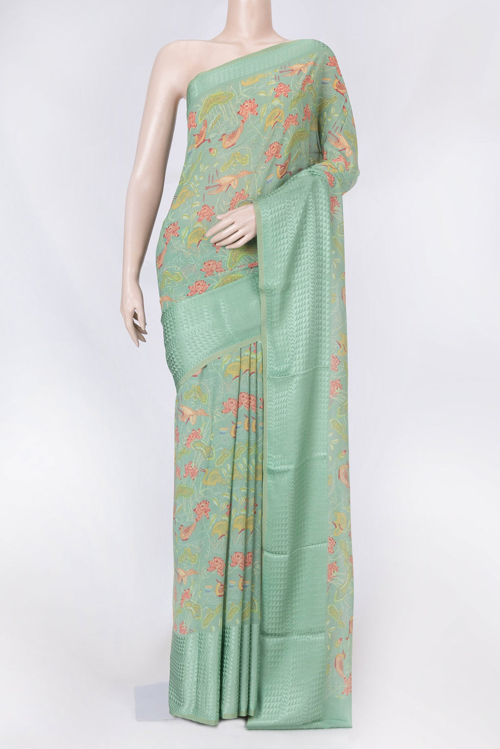 Green Dual Tone Mysore Georgette Saree with Printed design on the body and Thin Zari Line displayed on a mannequin