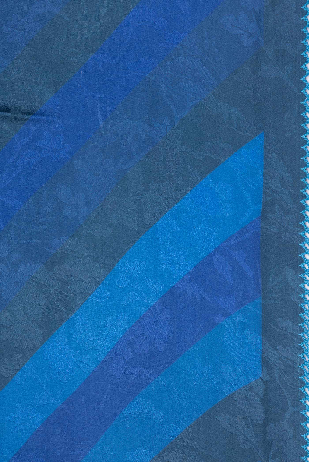 Border image of Blue Dual Tone Mysore Crepe Saree with Printed design on the body and Embroidery Border