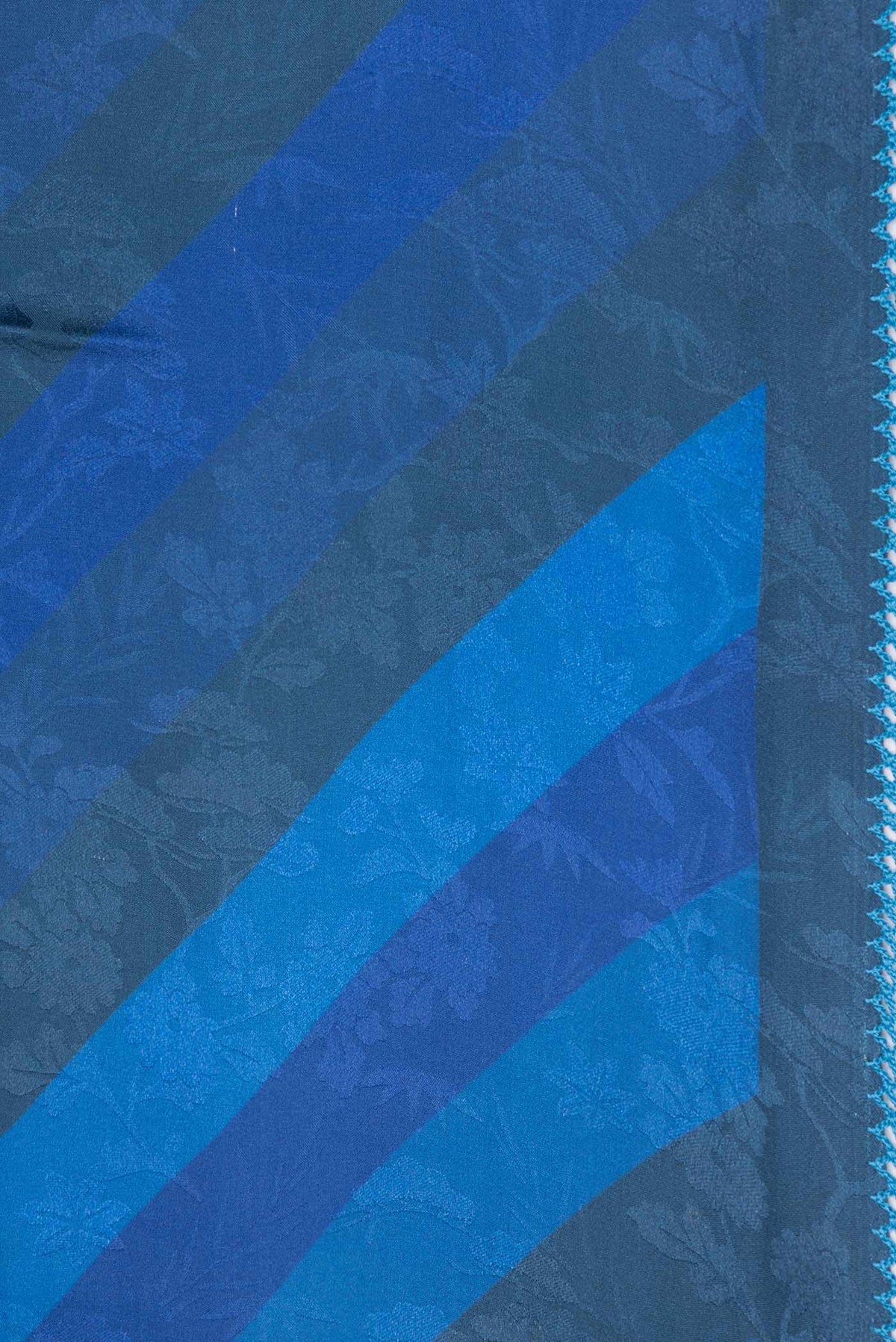 Border image of Blue Dual Tone Mysore Crepe Saree with Printed design on the body and Embroidery Border