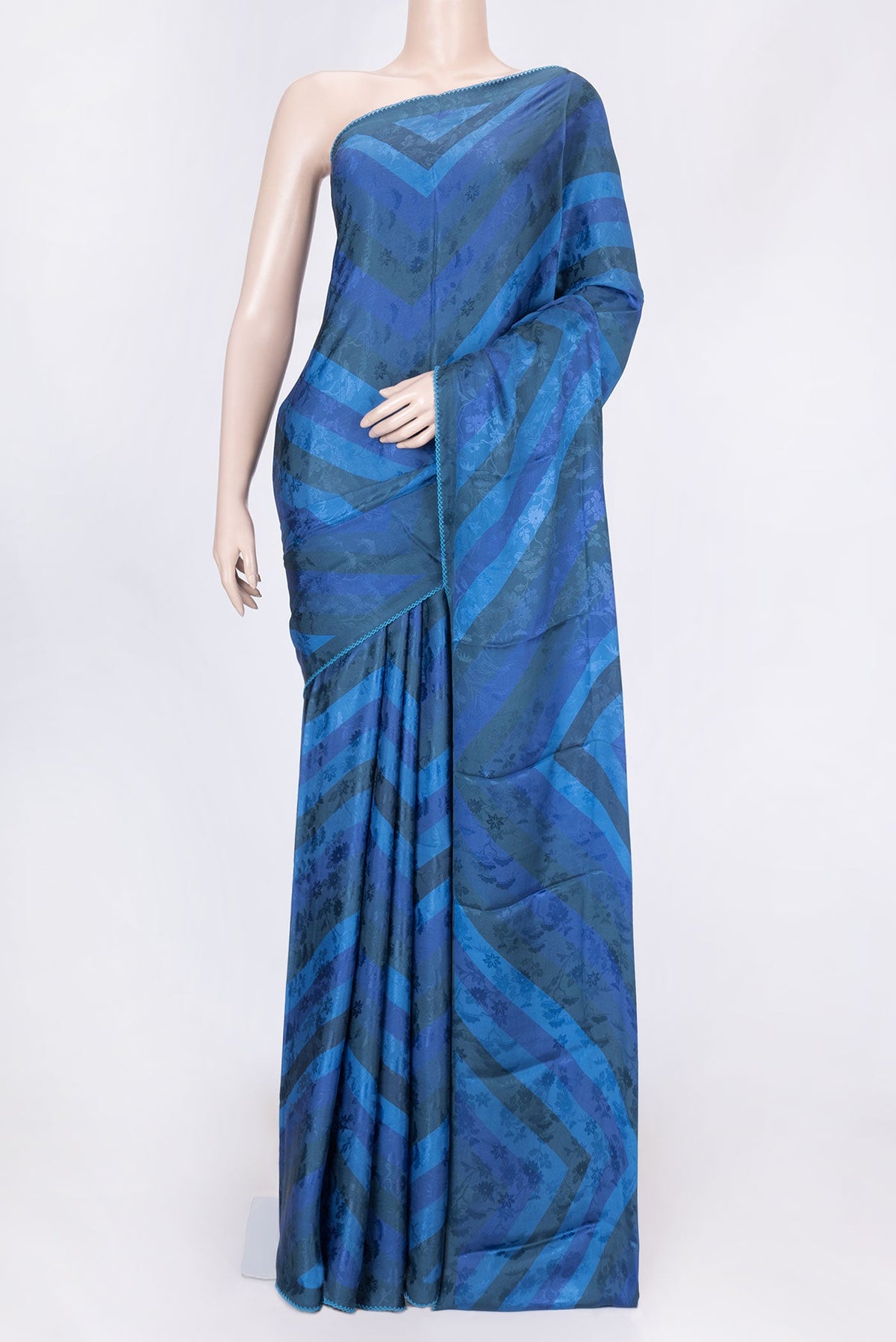 Blue Dual Tone Mysore Crepe Saree with Printed design on the body and Embroidery Border displayed on a mannequin