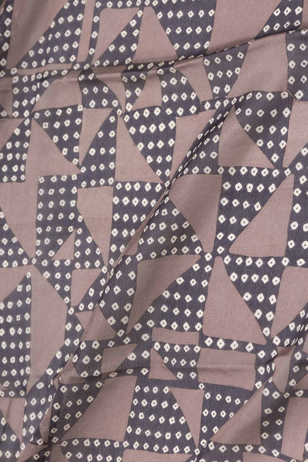 Close up of Brown Dual Tone Tussar Silk Saree with Printed design on the body and Zari Border displaying folds
