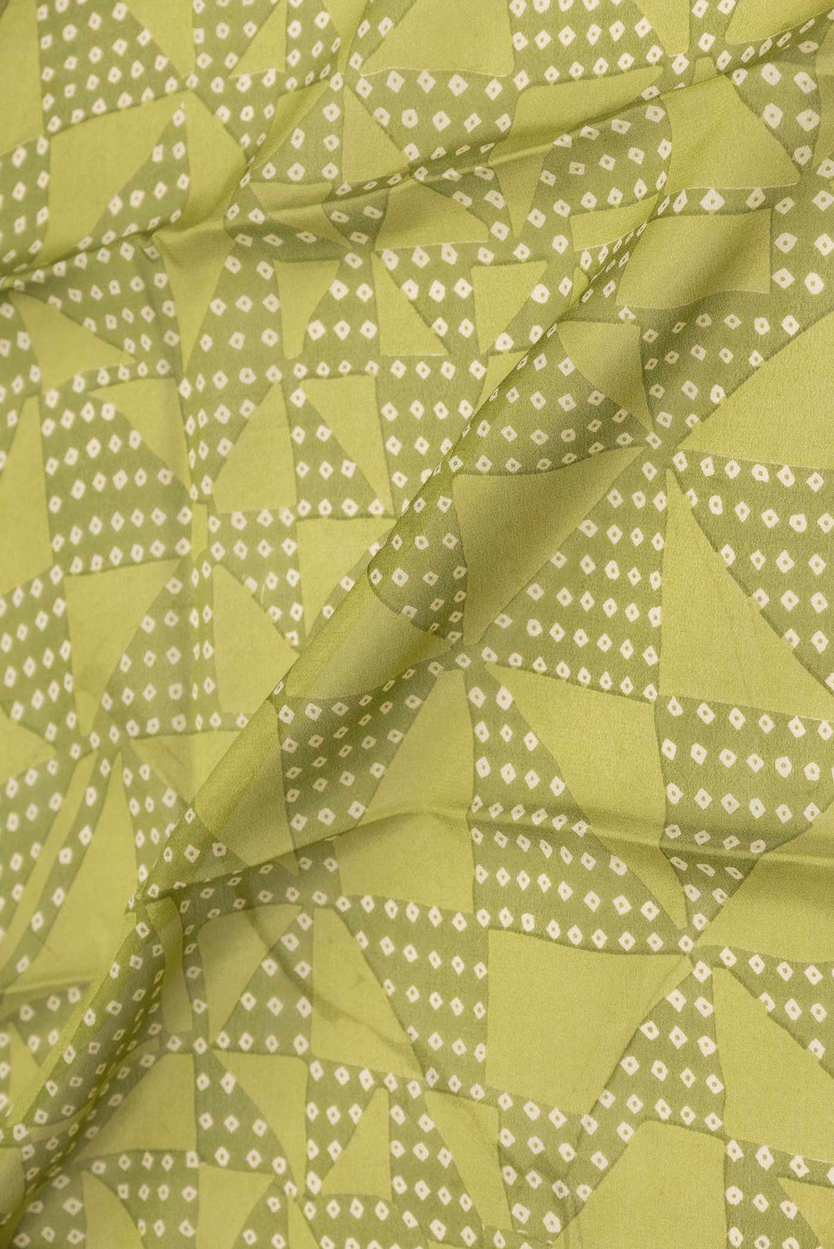 Close up of Green Mysore Crepe Saree with Printed design on the body and Zari Border displaying folds