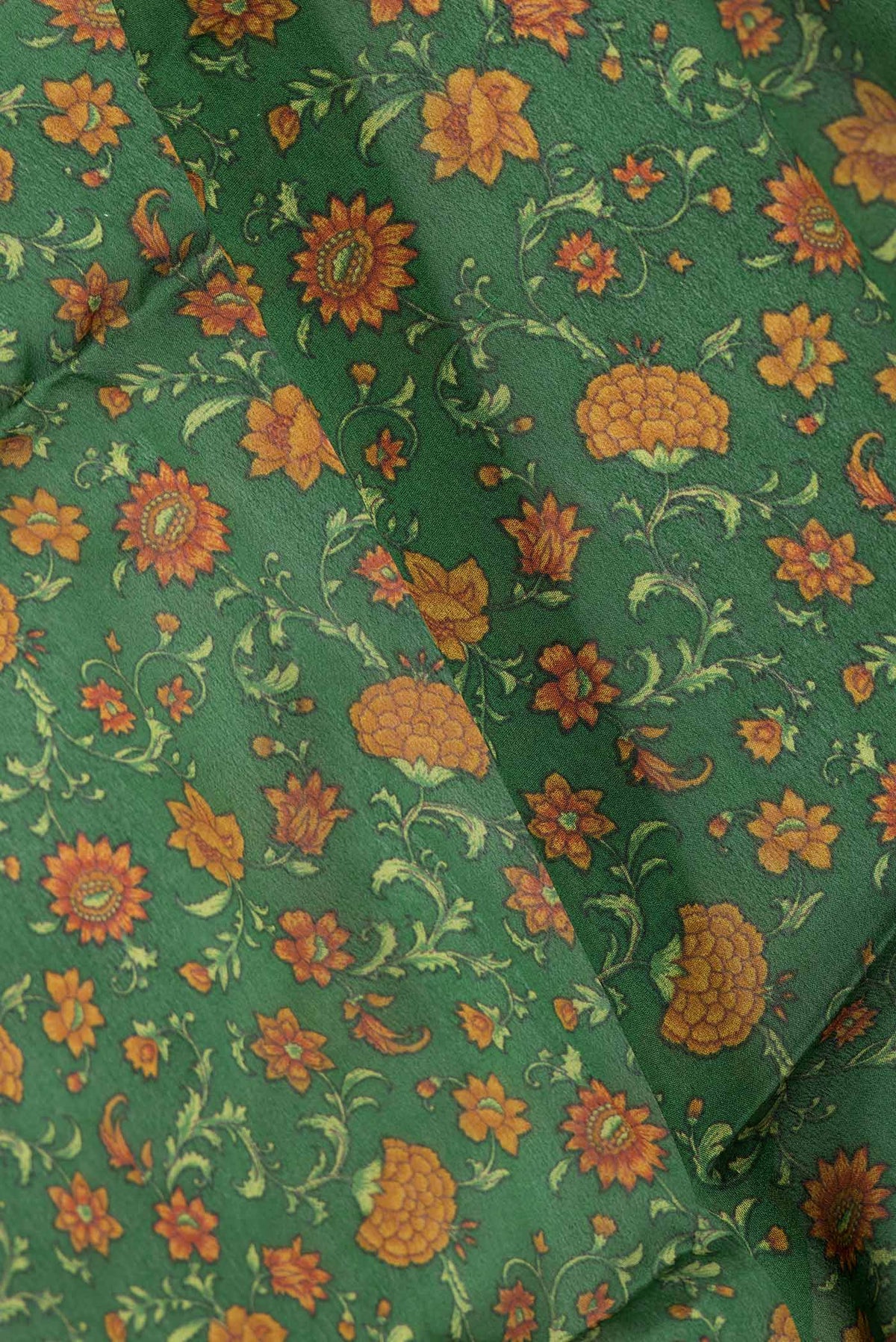 Close up of Green Dual Tone Mysore Crepe Saree with Printed design on the body and Zari Border displaying folds