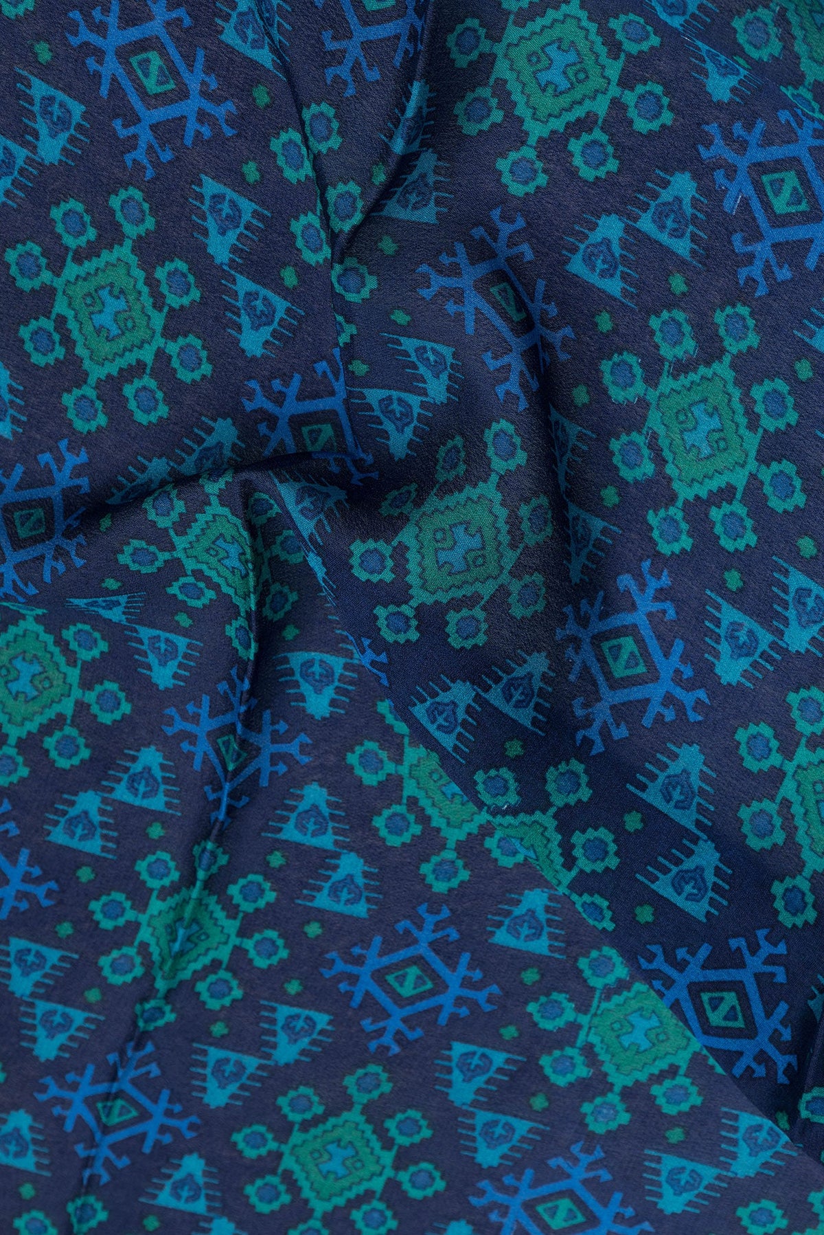 Close up of Navy Blue Dual Tone Crepe Saree with Printed design on the body and Zari Border.  displaying folds