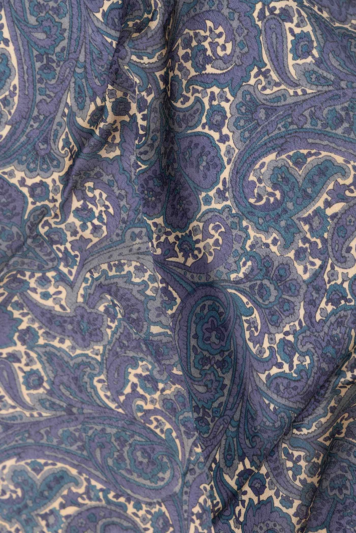 Close up of Blue Grey Dual Tone Mysore Crepe Saree with Printed design on the body and Zari Border displaying folds