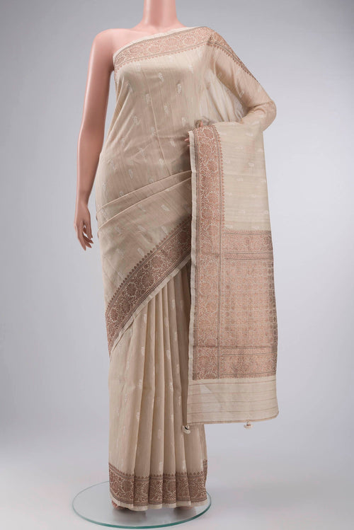 Beige Bhagalpuri Tussar Silk Saree with Embroidery on the body and Zari Border displayed on a mannequin